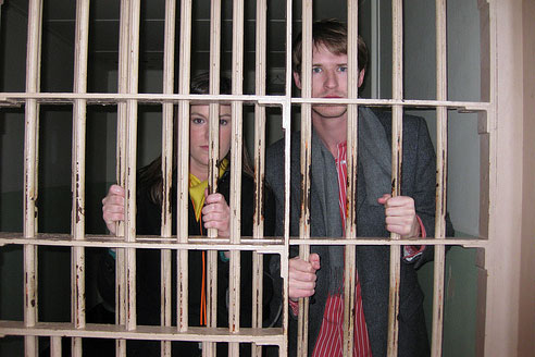 man & woman behind bars