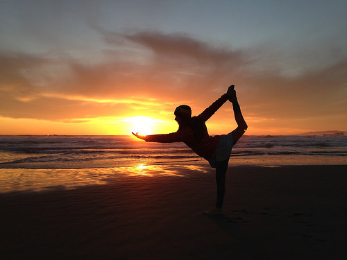 yoga posing sunset